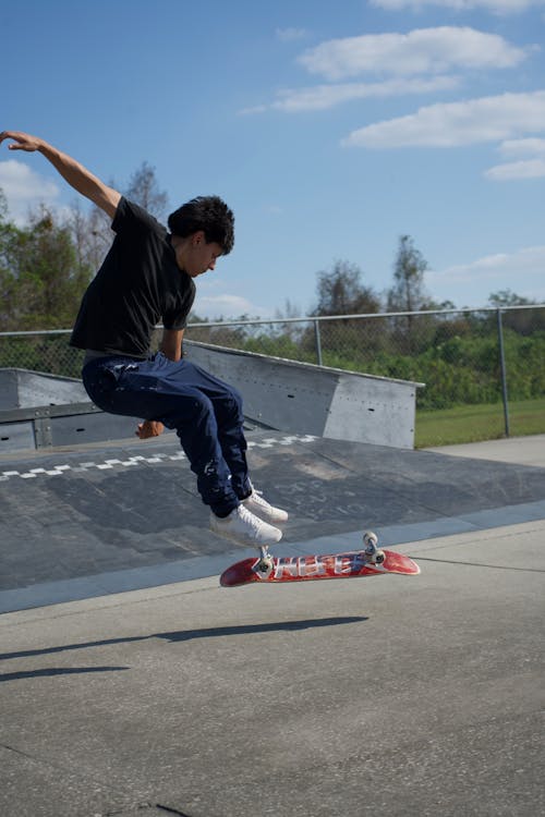 Young Man Jumping Midair on a Skateboard 
