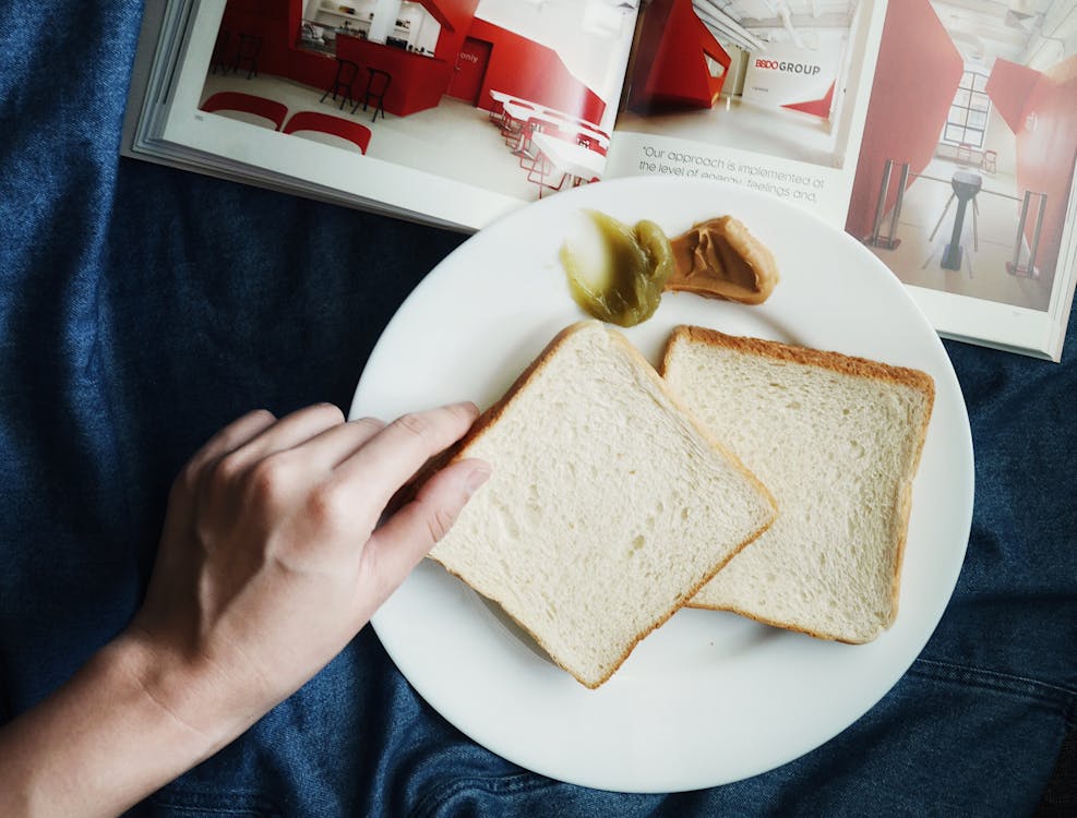 Free Person Touching the Bread on Plate Stock Photo
