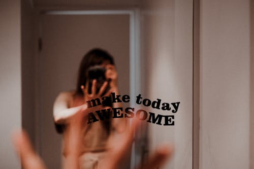 Text on Mirror with Woman Reflection