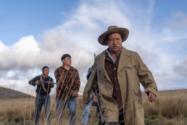 Men With Guns In Field Filming Western Movie