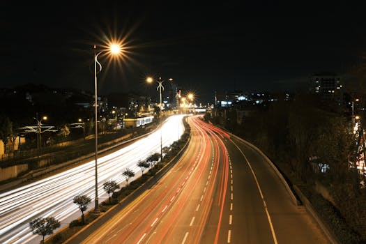 Vibrant long exposure photo of a busy highway at night, showcasing dynamic city lights and motion.
