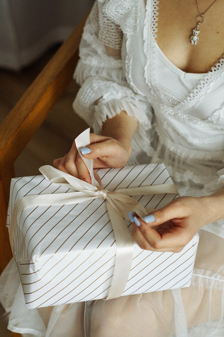 Woman In Dress Unpacking Present