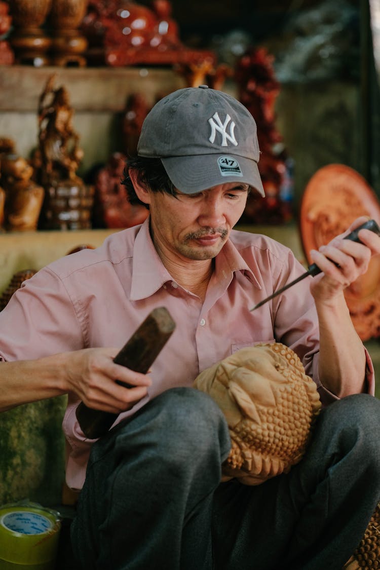 Man Carving On Wood