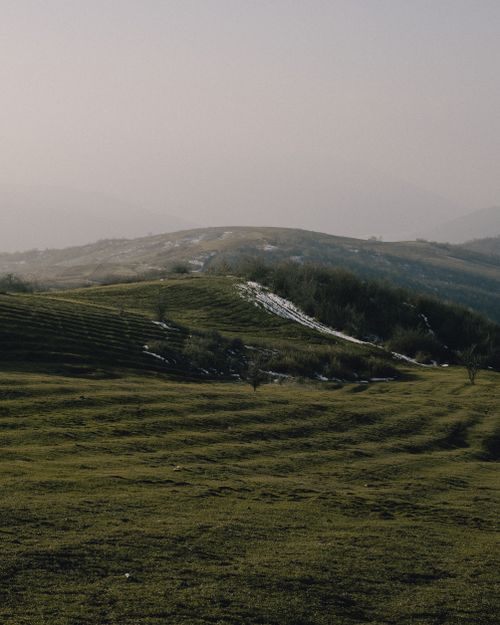 Free Beautiful rolling hills in Shamakhi, Azerbaijan under a calm sky, showcasing tranquil rural scenery. Stock Photo