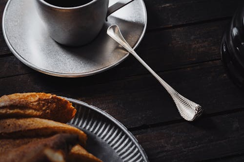 Free Close-up of Toasted Bread on a Plate and a Cup with a Drink on a Table  Stock Photo