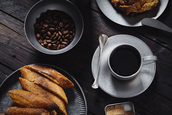 Overhead view of coffee, pastries and roasted beans on a dark table, photo by COPPERTIST WU on Pexels