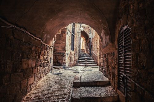 Free A narrow, stone-paved street in the historic Old City of Jerusalem, Israel. Stock Photo