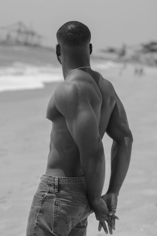 Free Monochrome image of a topless man standing at a beach in Cape Town. Stock Photo