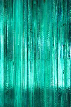 Vibrant abstract image displaying a close-up of a metallic green textured surface with vertical lines.