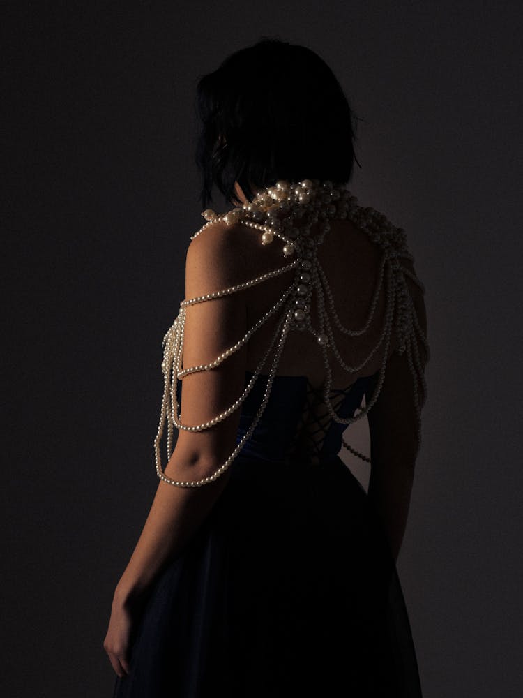 Back Of A Woman In A Dress And Jewelry