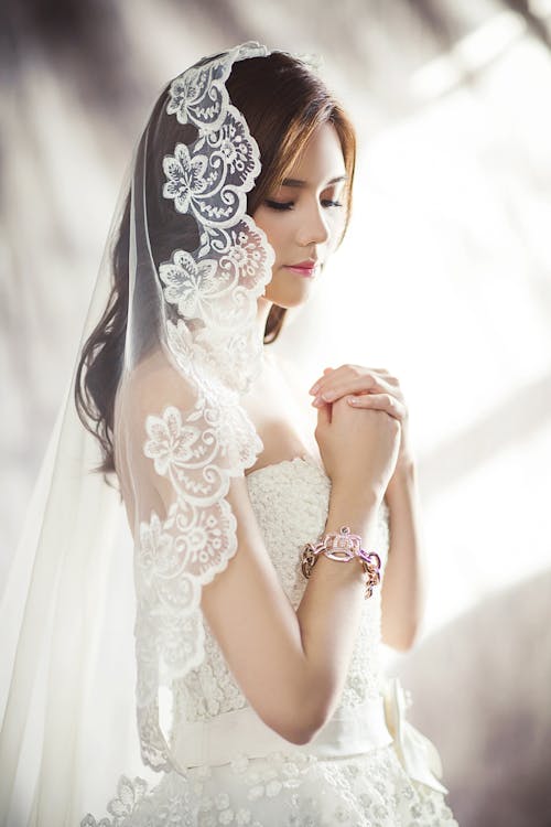 Free Woman in White Bridal Gown Meditating Stock Photo