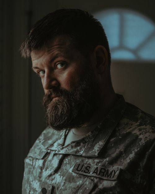 Free A contemplative male veteran with a beard wearing a US Army uniform indoors in Portland, Oregon. Stock Photo