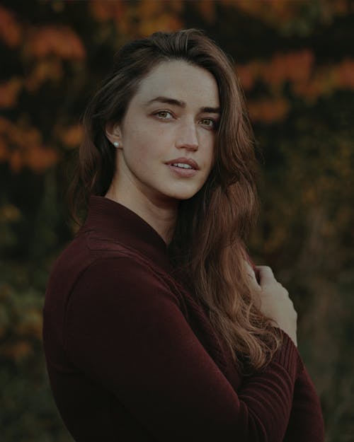 Portrait of a Woman in a Burgundy Sweater in Autumn Forest