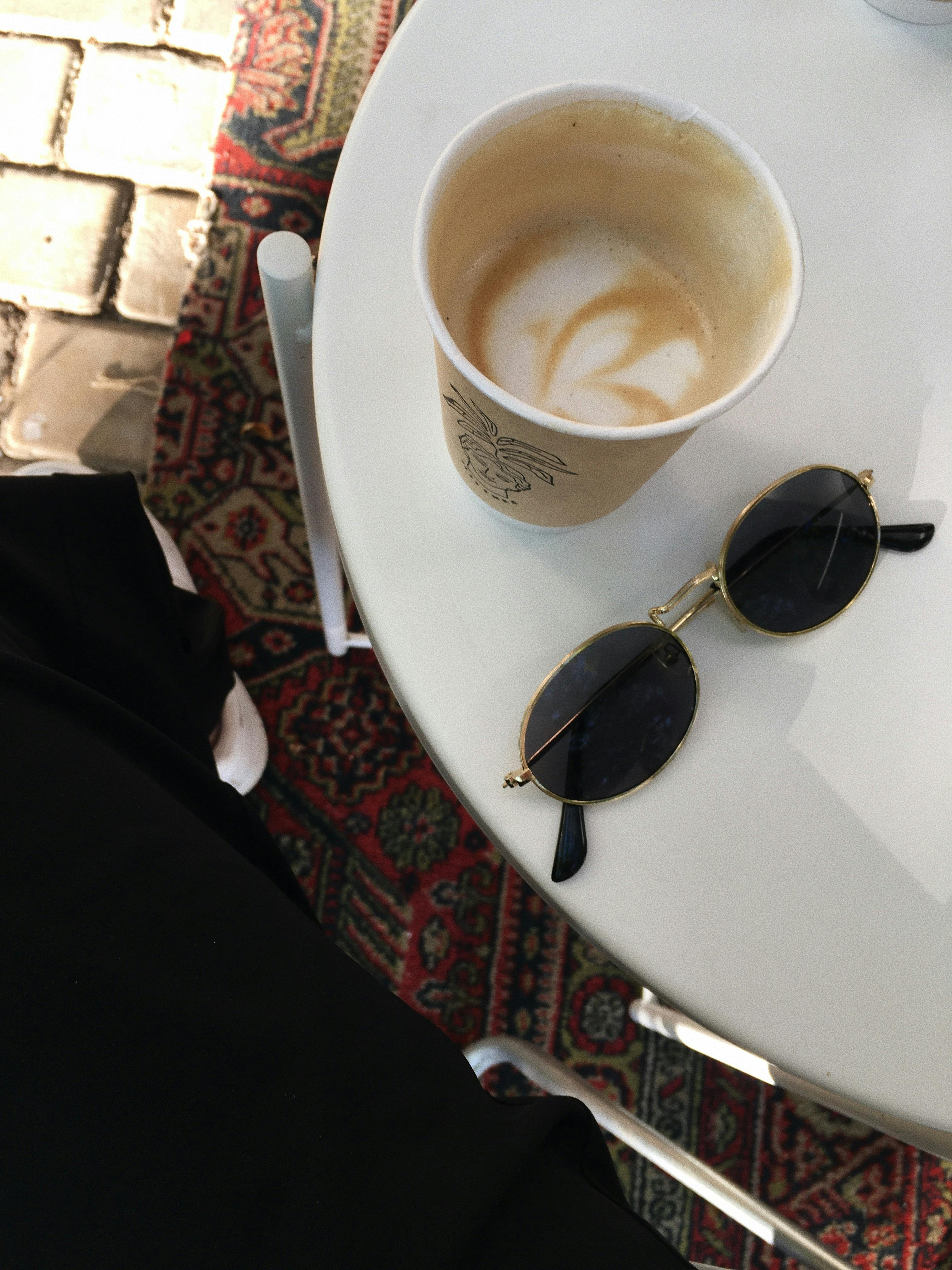 Sunglasses on Table with Coffee