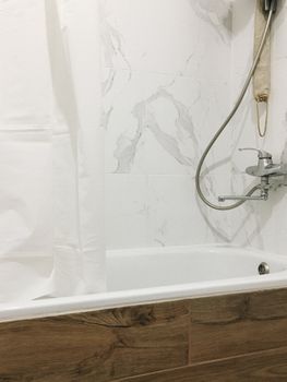 A modern bathroom with marble tiles, bathtub, and minimalist fixtures, perfect for home decor inspirations.