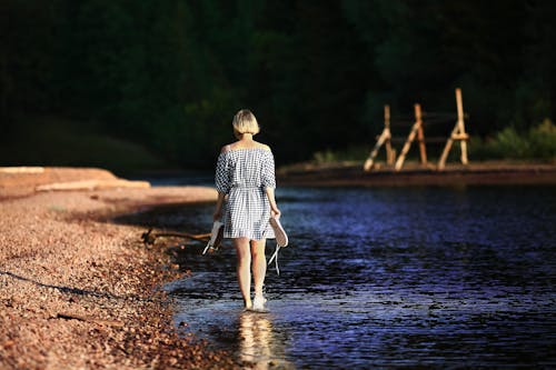 Женщина, идущая возле водоема