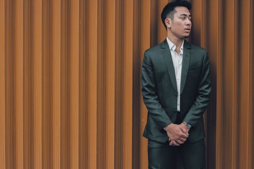 A man in a suit and tie looking down · Free Stock Photo
