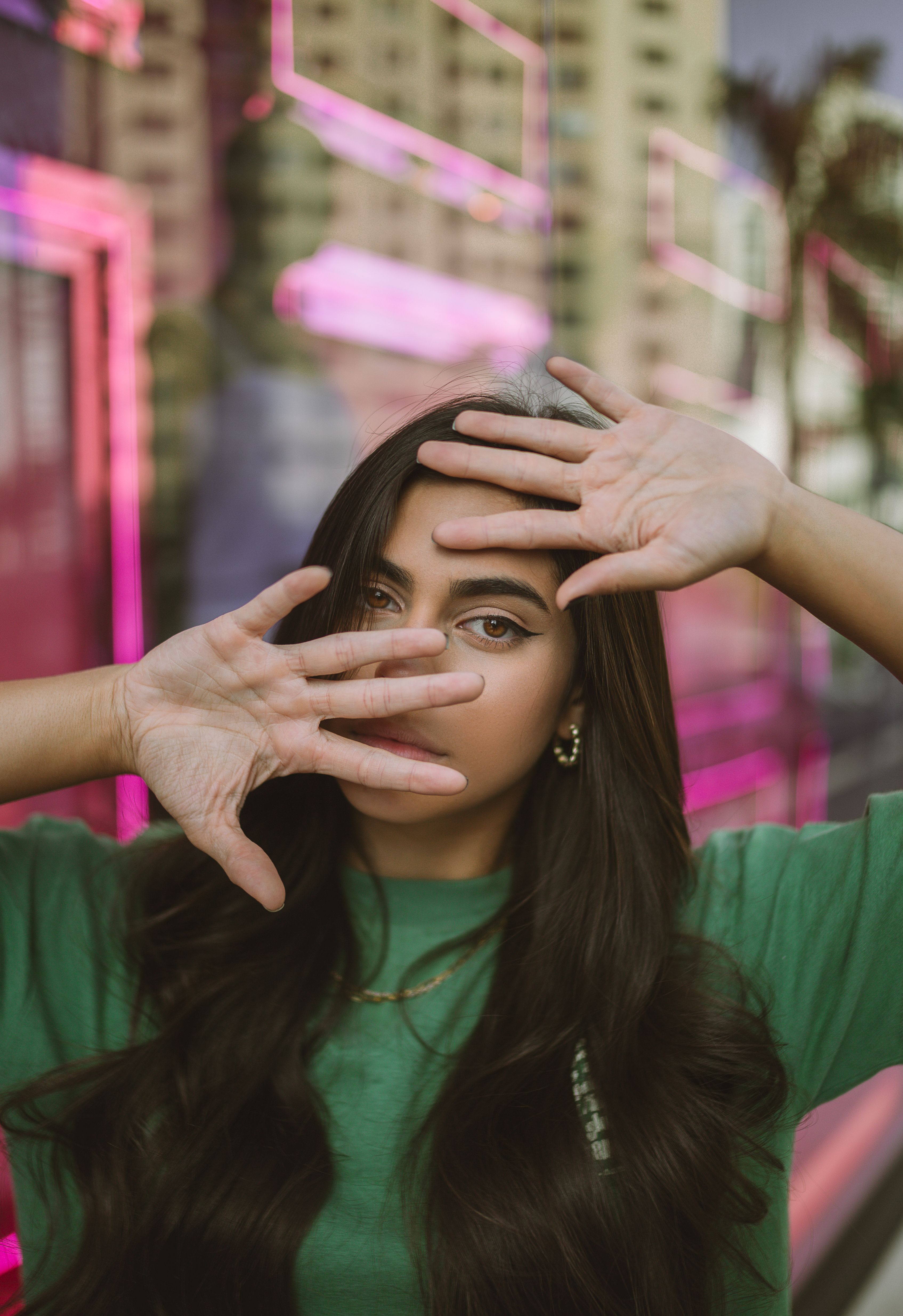Portrait of a Young Brunette Covering Her Face with Hands · Free Stock ...