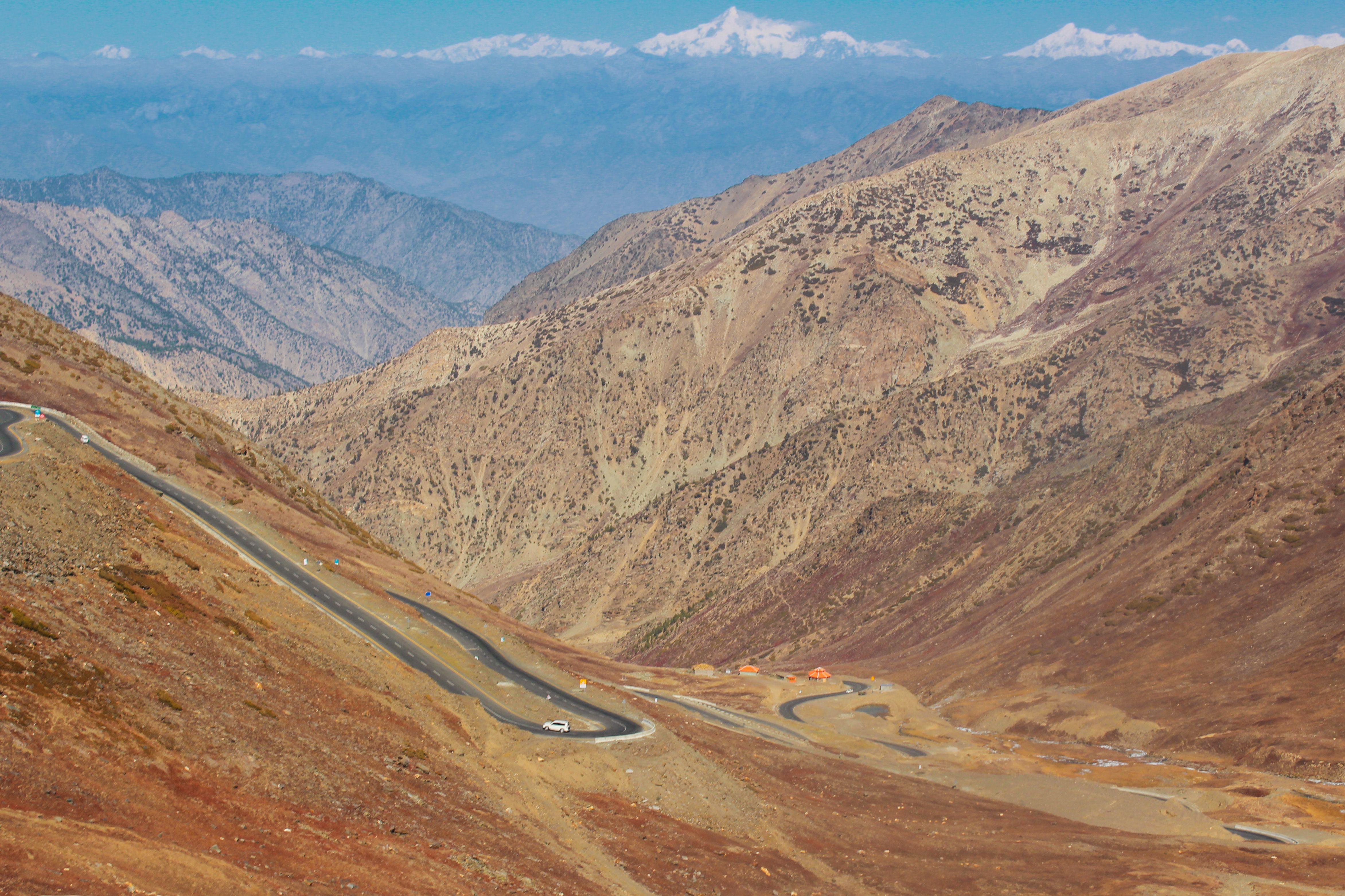 Breathtaking view of a winding road traversing the arid mountains in Kaghan Valley, Pakistan.