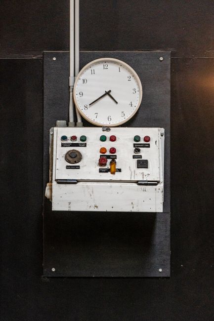 Close-up of a vintage industrial control panel with a wall-mounted clock, Murwillumbah, NSW.
