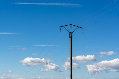 View of a Utility Pole under Blue Sky 