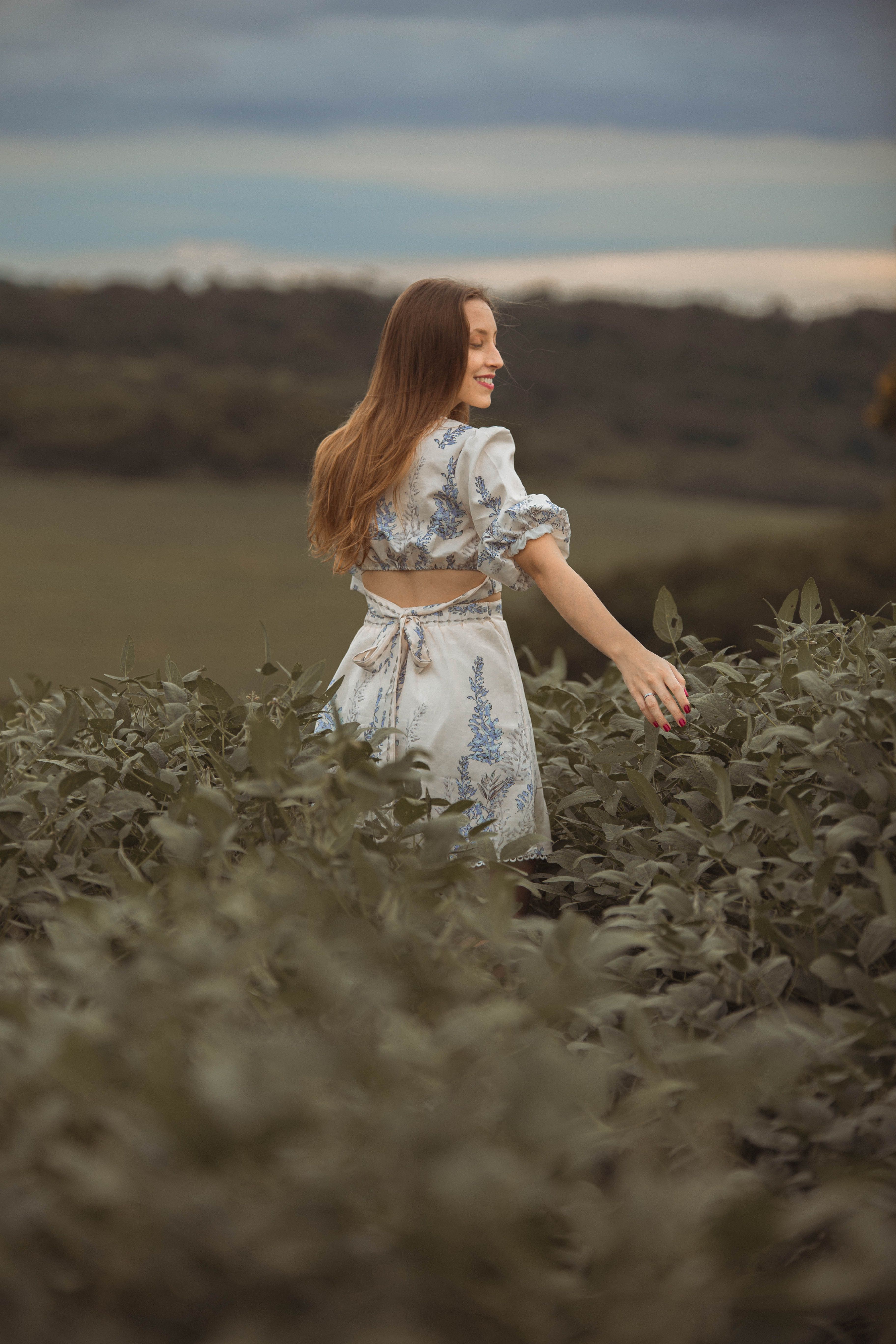 Smiling Woman in a Dress Walking Through the Crops · Free Stock Photo