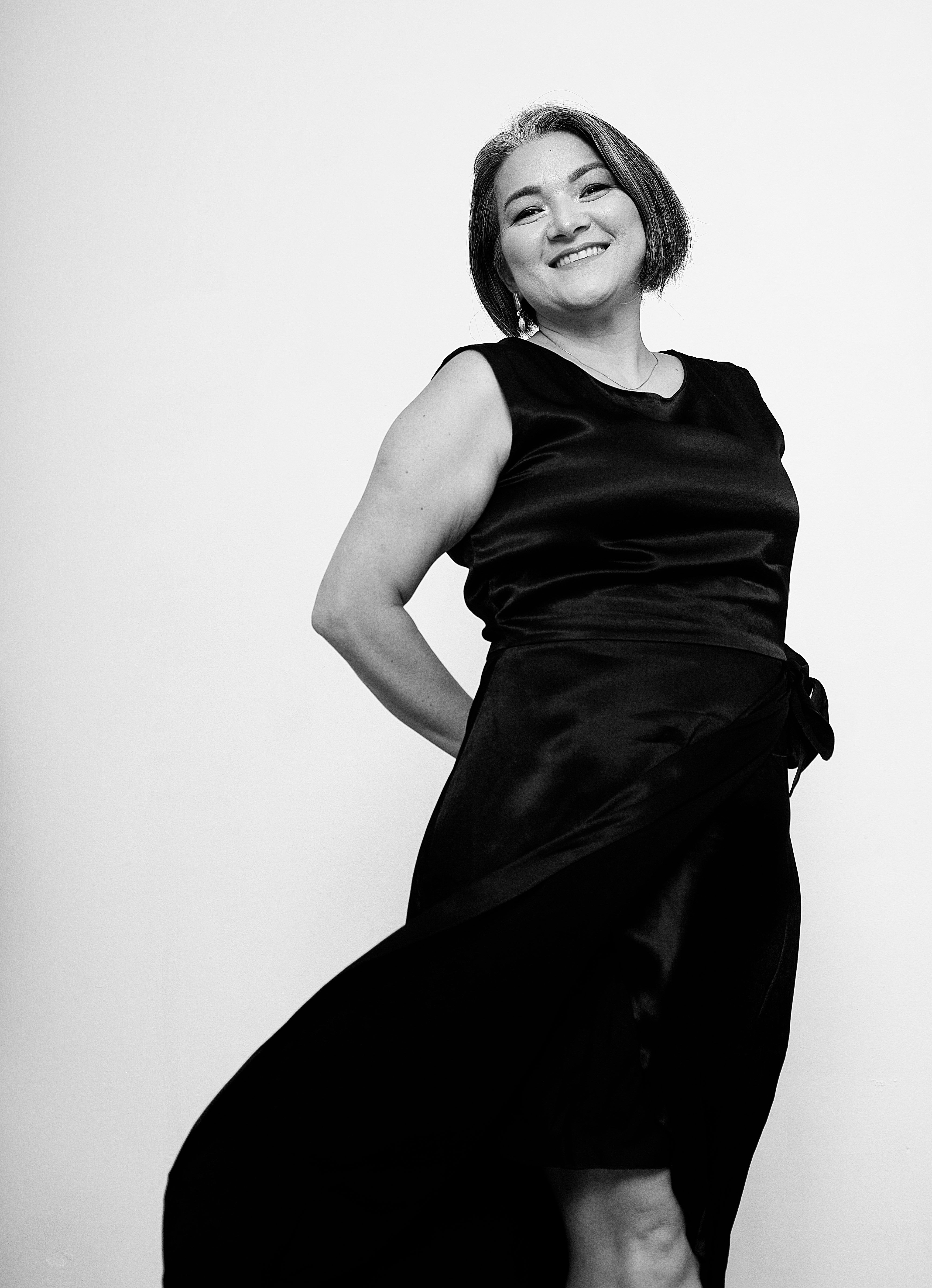 Black and White Shot of a Smiling Woman in a Dress · Free Stock Photo
