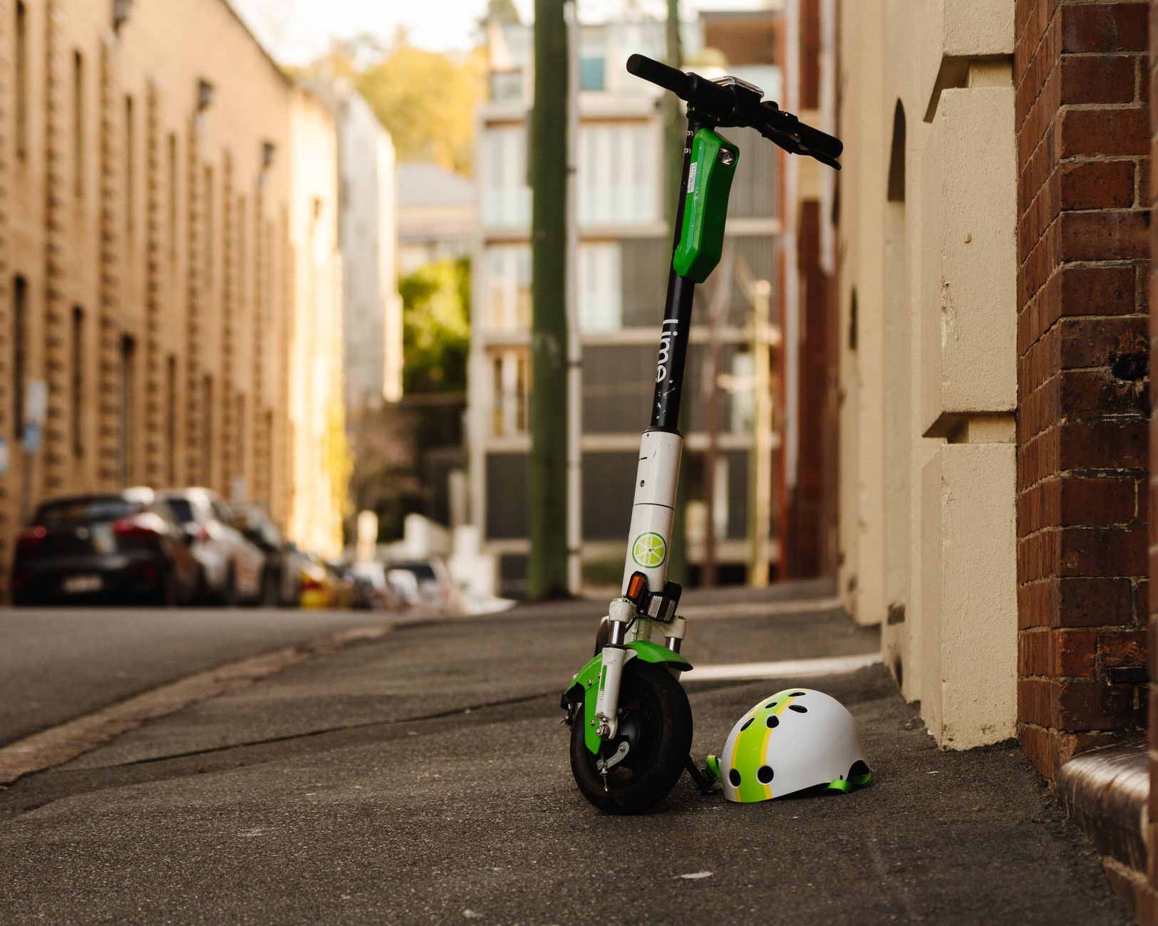 Electric scooter with helmet on a sidewalk in Teneriffe, Australia.