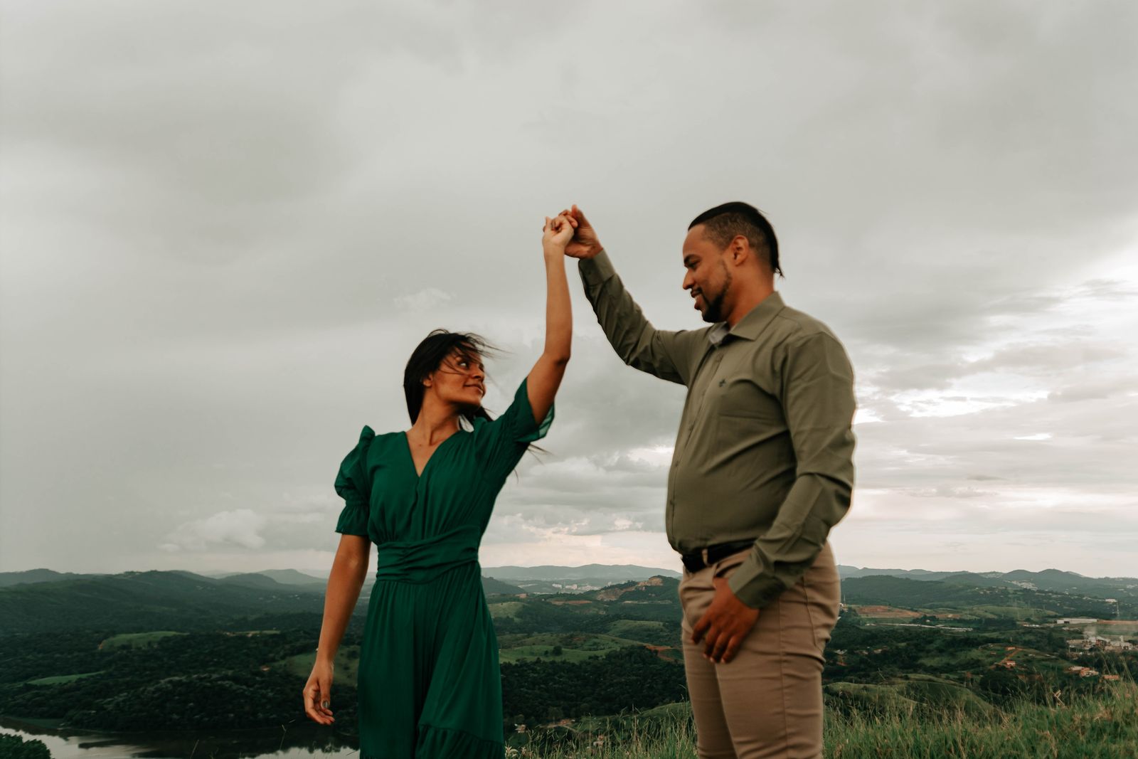Two people holding hands in an open landscape