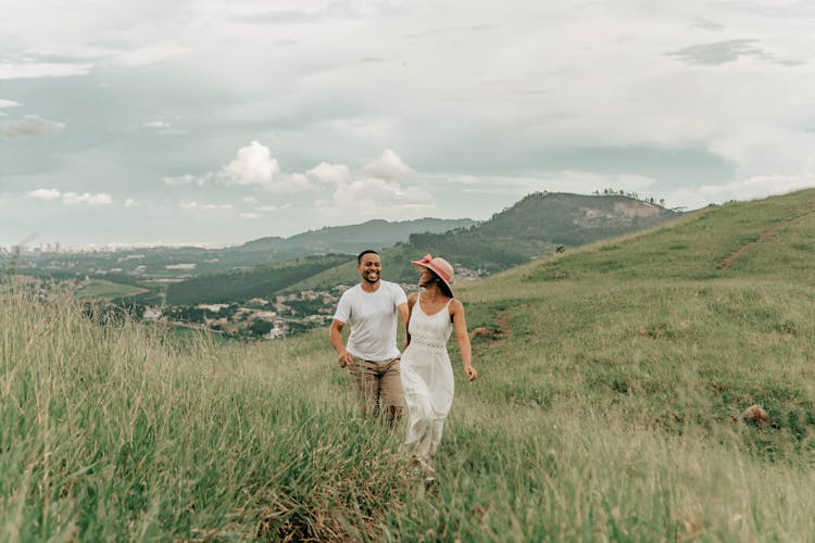 Man And Woman Walking In Mountains