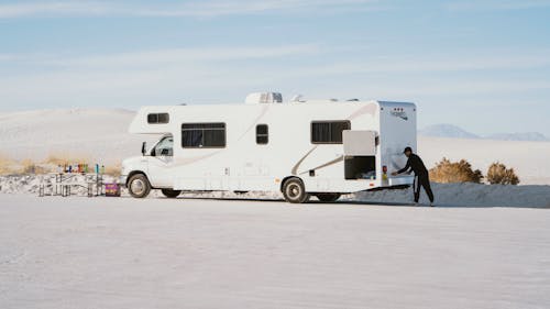 Men Standing next to Camper Van