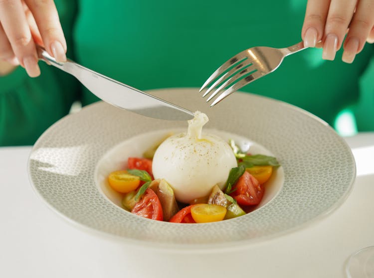 Woman Fingers Holding Fork And Knife Over Plate