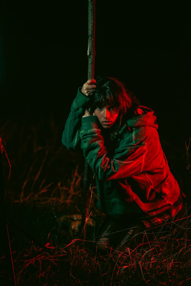 Woman In Jacket Posing By Tree At Night