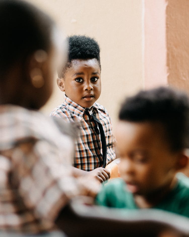 Young Boy Watching Children Play