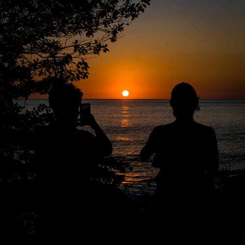 Couple Looking at Sunset over Sea