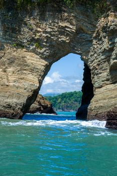 Explore the stunning natural rock arch formation at Puntarenas, Costa Rica's beautiful coastline.