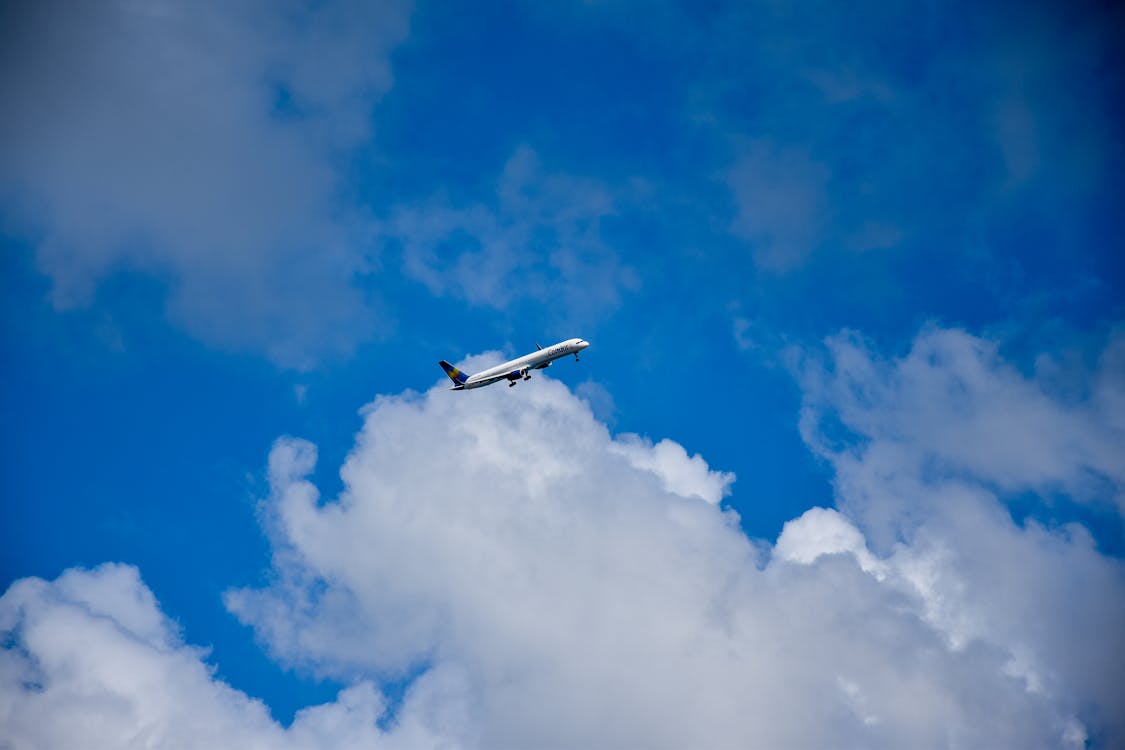 Free stock photo of airplane, blue sky, clouds Stock Photo
