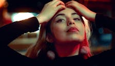 在城市夜灯下，时尚女性自信地摆着姿势