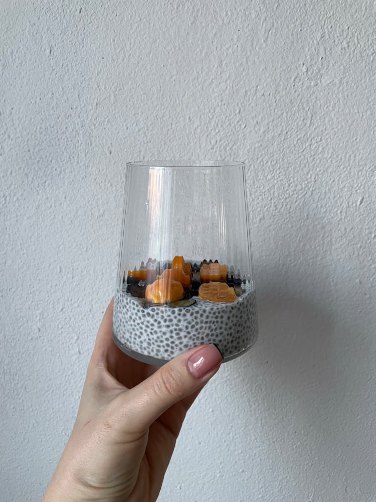 Woman Hand Holding Glass With Chia Pudding