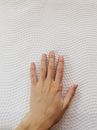 Left Human Hand on Quilted White Surface