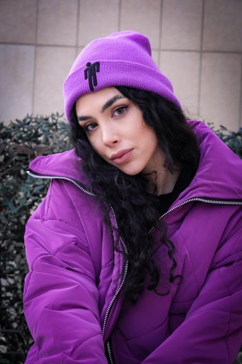 Young Brunette in a Purple Jacket and Hat 