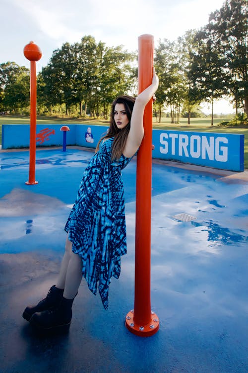 Young Woman in Blue Dress in a City Park