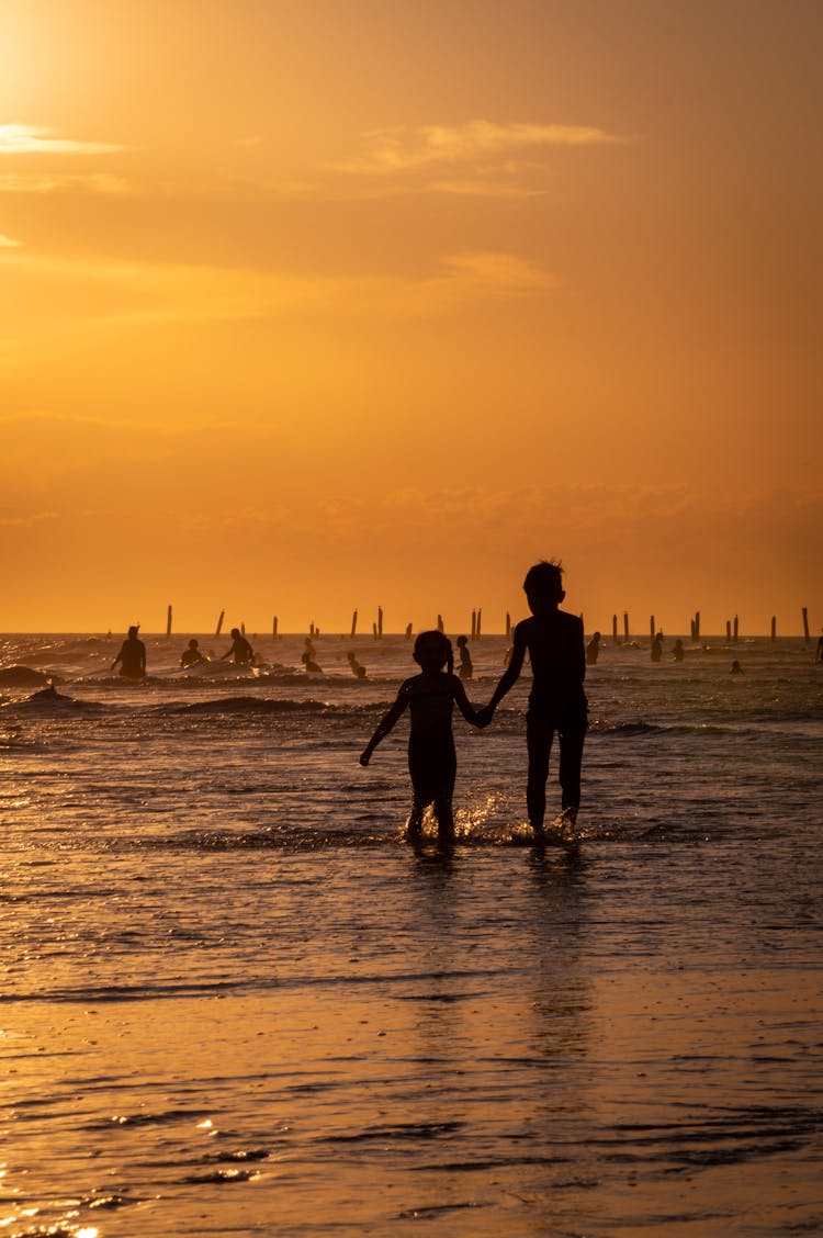 Children Together On Sea Shore At Sunset