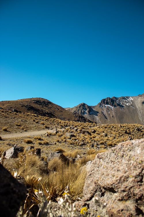 Free Stunning view of an arid mountain landscape with clear blue sky and rugged terrain. Stock Photo