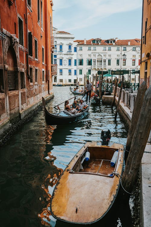 Gondolas in a Canal between Buildings in Venice, Italy 