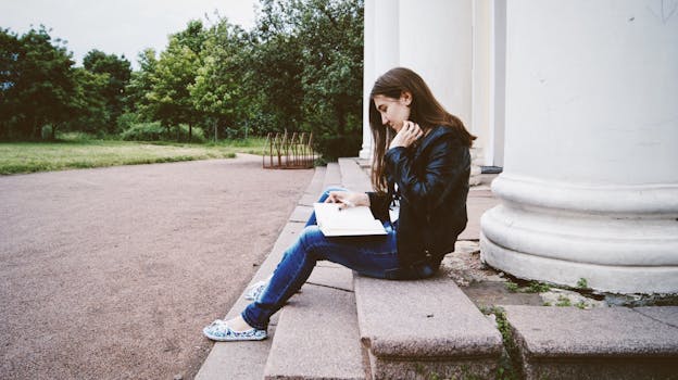 Woman in Black Leather Jacket Siting on Concrete Stairs