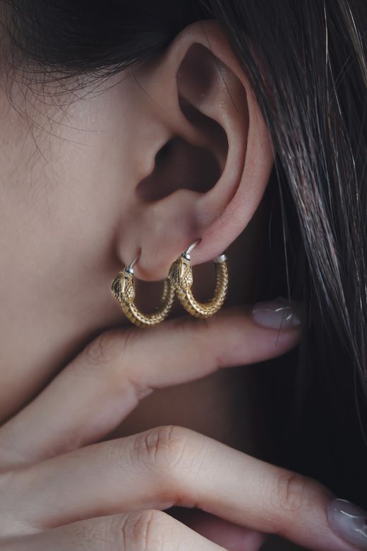 Gold hoop earrings worn close up &mdash; photo by COPPERTIST WU on Pexels