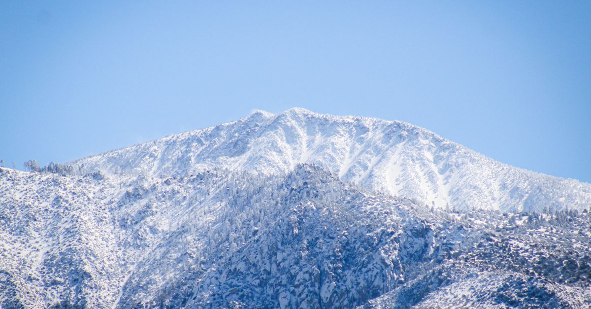 Majestic snow-covered mountain peaks under a clear blue sky in Los Angeles, CA.