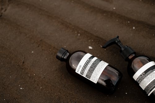 Soap in Bottles on a Beach 