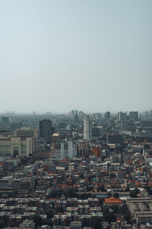 Free Panoramic aerial view of Jakarta's dense urban cityscape highlighting modern skyscrapers. Stock Photo